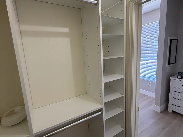New walk in closet facing vanity and second window