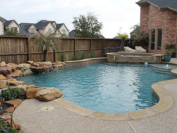 Sparkling pool, with spa and water fall.