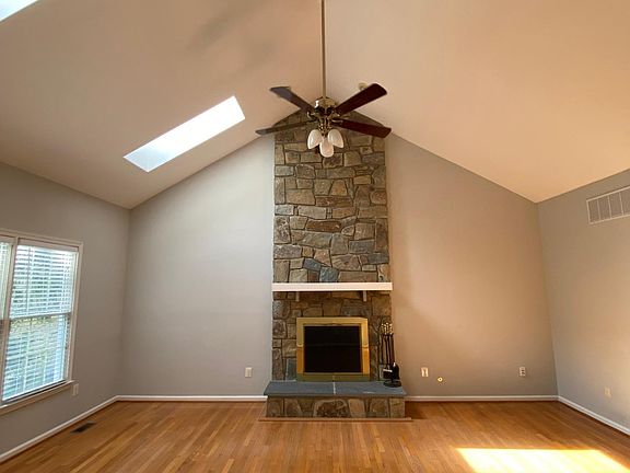 Family room with cathedral ceiling and sky light windows