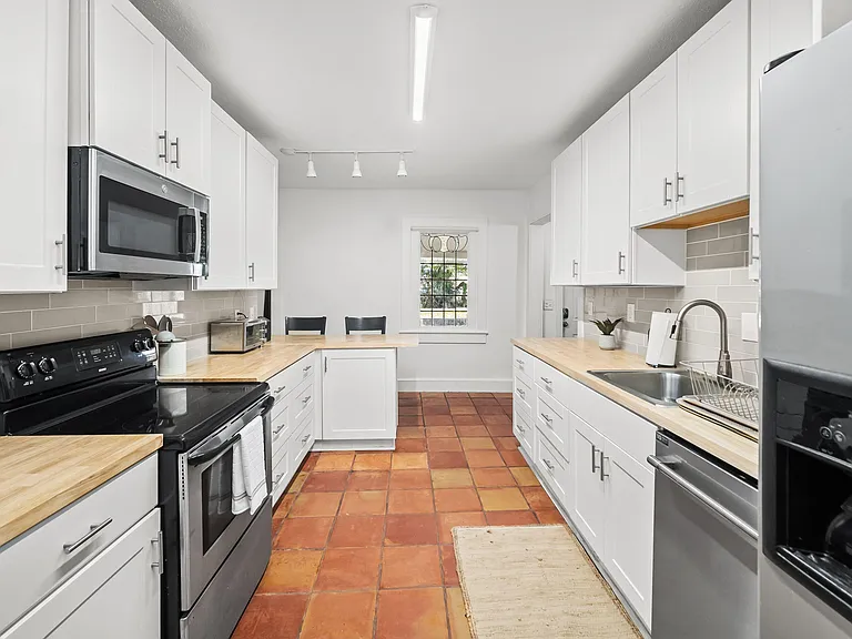 Kitchen area with oven, toaster oven and microwave