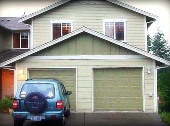 Front of the house with one car garage and private parking.