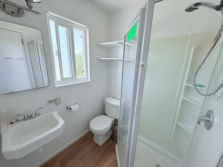 Bathroom right off the kitchen with grey water system.
