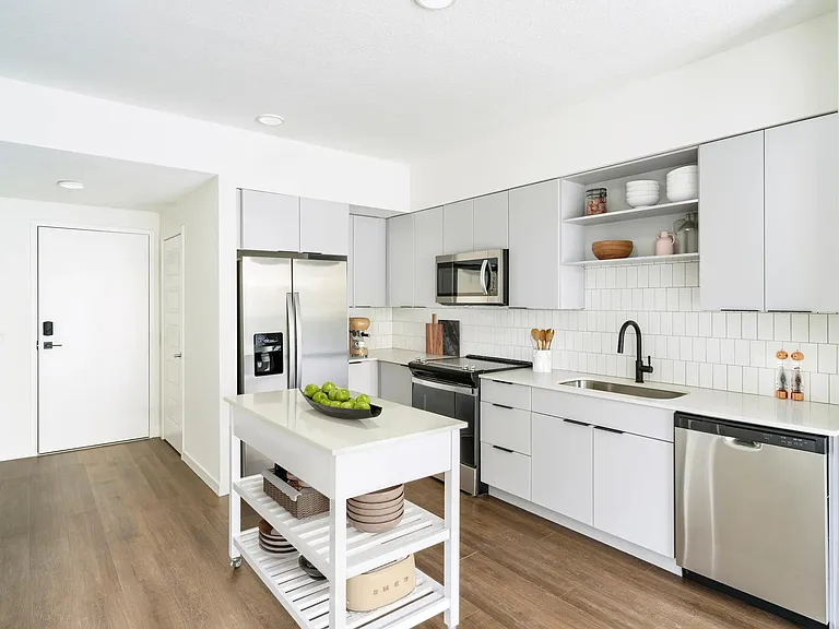 A light-cabinet kitchen with a movable island offers flexible, effortless living throughout your Modera Encore Tampa home.