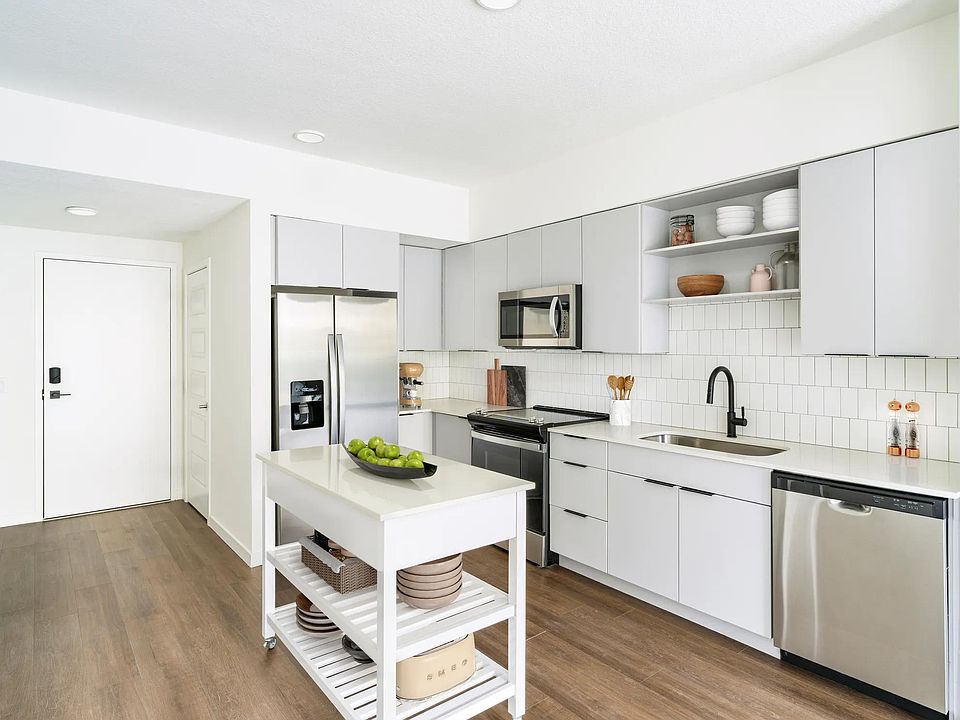 A light-cabinet kitchen with a movable island offers flexible, effortless living throughout your Modera Encore Tampa home.