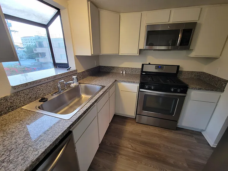 Kitchen: Granite Countertop, Dishwasher, Stainless Steel Sink w Garbage Disposal, Stove, Microwave & Lots of Cabinets