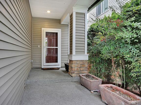 Extended porch entry w/ storm door.