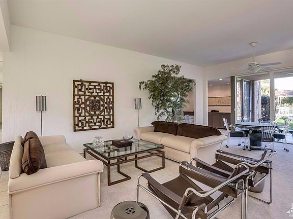 The spacious main living room offers plenty of room for guests. The plush carpeting adds to the comfortable feel of this space.