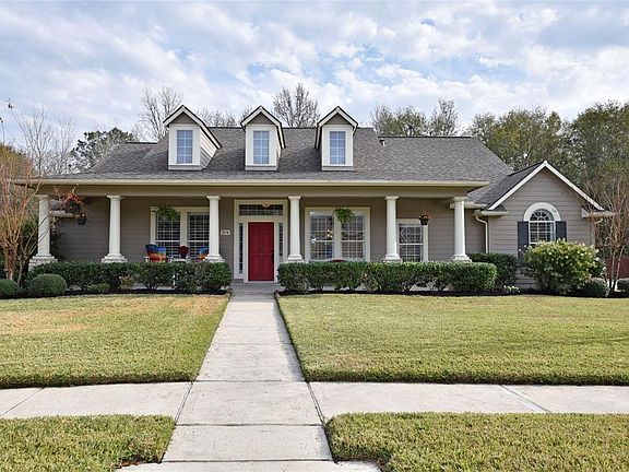 Classic front porch with stone based pillars. NOTE: The dormers have remote control lights enhancing the pleasant evening view of the home. Great landscaping with crepe myrtles anchoring each corner, full sprinkler system. NEVER flooded and seller ha