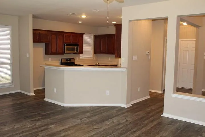 View of kitchen from den with breakfast bar.