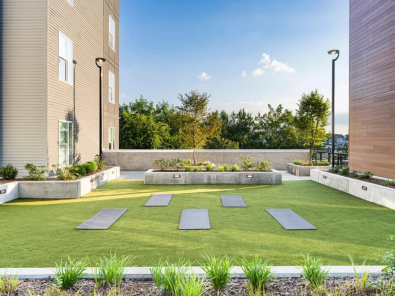 Outdoor yoga and wellness lawn designed for movement and relaxation at Modera LoSo.