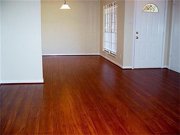 Entry opens to Formal Living & Formal Dining.  Beautiful laminate floors, updated lighting, and neutral paint.