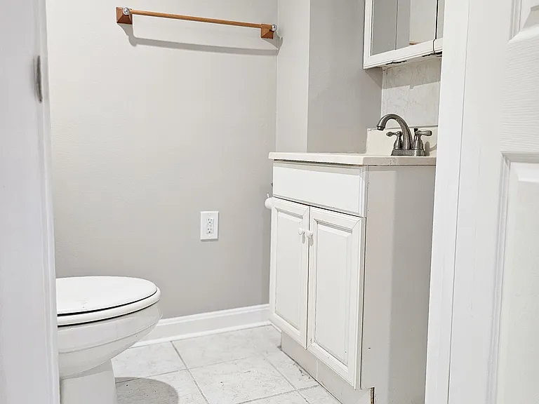 Basement bathroom with vanity and toilet