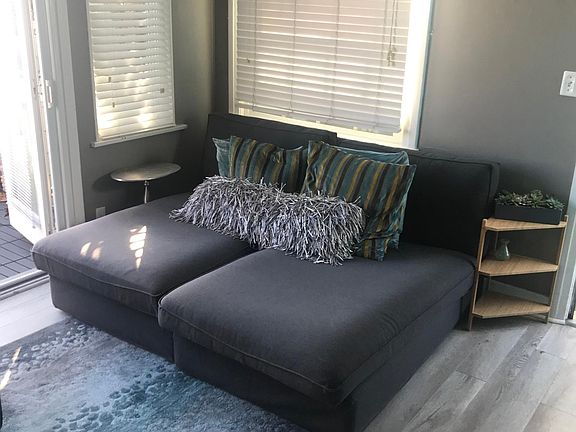 Living room with direct access to sunny deck , retractable awning, sunset view ,weathered driftwood woods flooring,