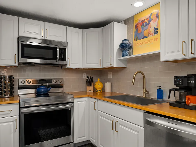 The fully stocked Kitchen includes a microwave, oven with "Air Fry" setting, large sink, dishwasher, and fridge with ice maker. Also provided are toaster, Pots & Pans, Spice rack, measuring cups, cutting boards, mixer, knives, bowls, and cooking utensils