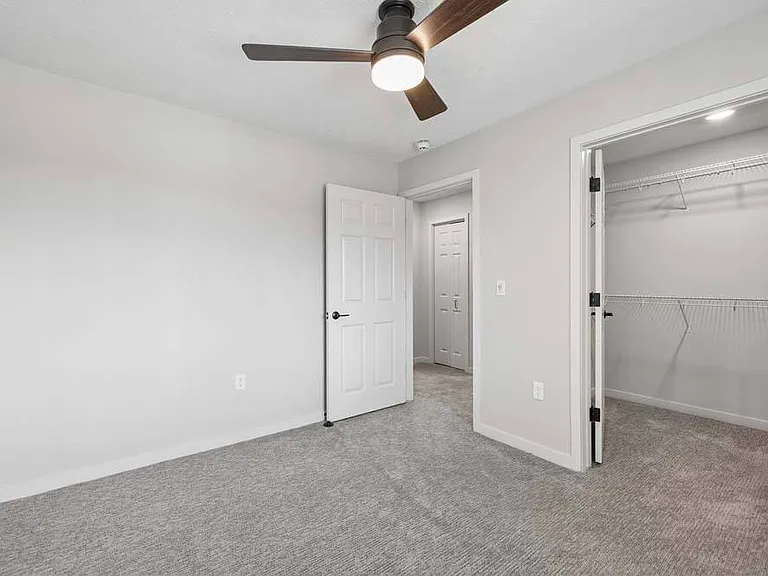 An airy bedroom with generous closet space provides a comfortable retreat designed for both relaxation and everyday ease.