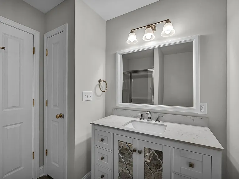 Primary bath vanity and linen closet.