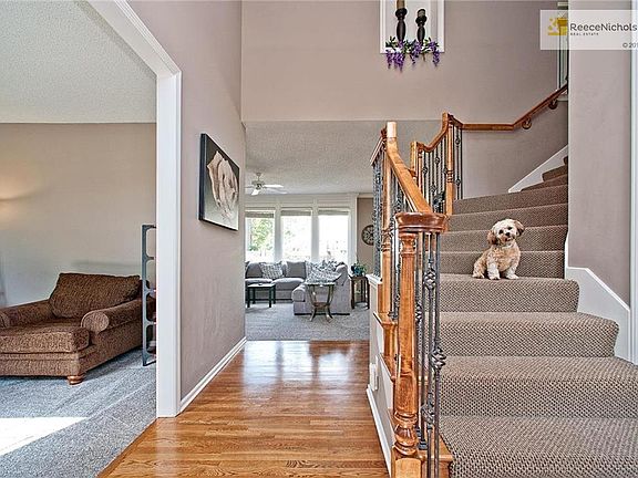 2 Story Entry w/Hardwood Floors!  Staircase w/Wood End Caps, Wrought Iron Spindles & Upgraded Stair Carpet!