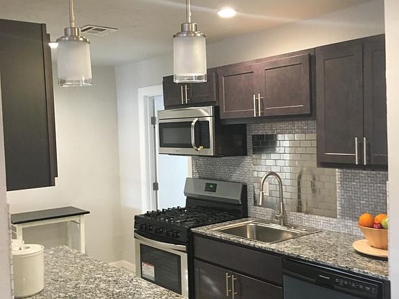Open kitchen with new tile floor off dining and living area