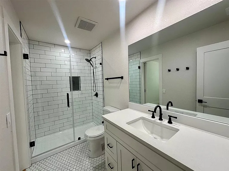 Large upstairs hallway bathroom shared by tenant of primary bedroom and one tenant of a secondary bedroom.