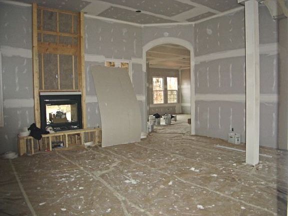 Double stone fireplace between Living Room and Screened Deck
