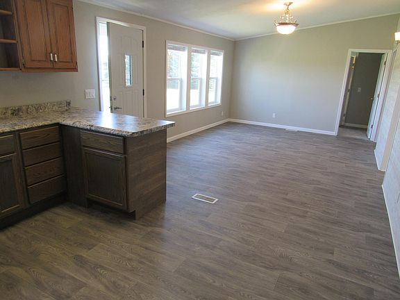 Main room showing front door, dining area would be in bottom right hand corner