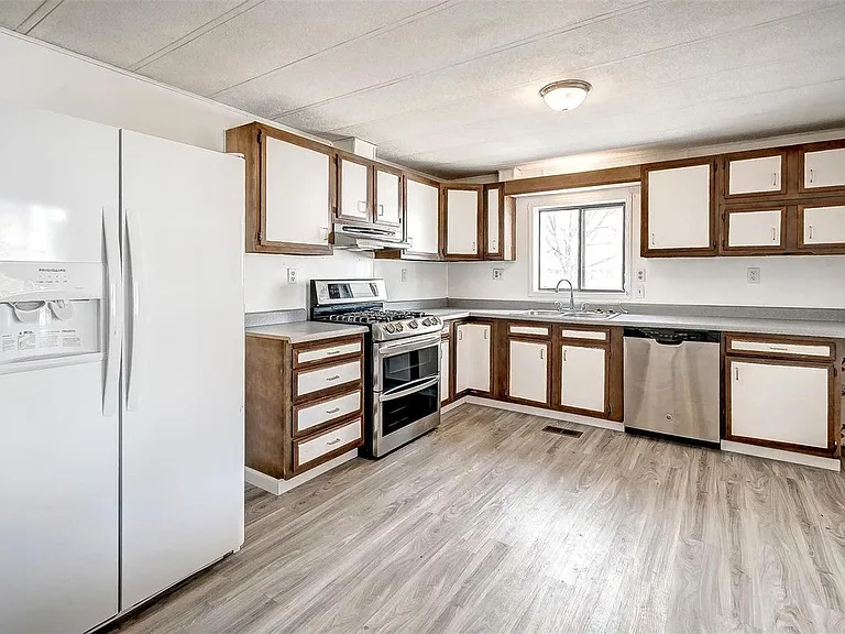 Large kitchen and dining room with new gas cooktop, 2 ovens, double sink, dishwasher, large refrigerator and freezer, and lots of cabinet space.