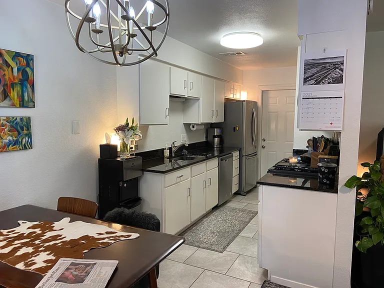 Galley Kitchen - granite counters and stainless appliances, and walk-in pantry