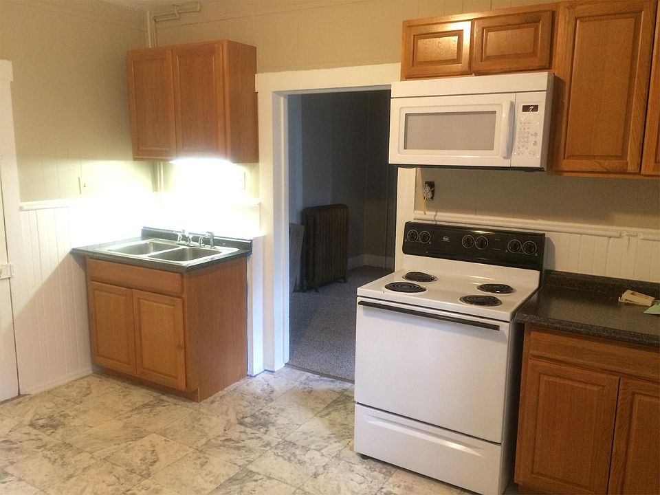 Kitchen with fridge, dishwasher, washer and dryer.