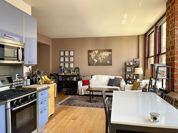 Spacious open loft-style layout with modern kitchen and restored original details