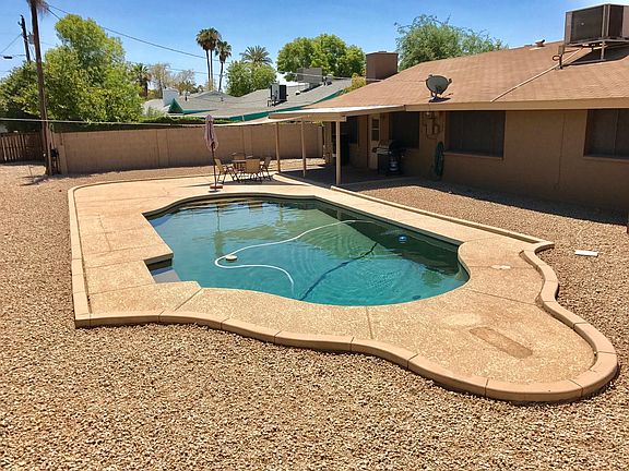 Large back yard with a large diving pool. New pebble tech, pool decking, and pool equipment.