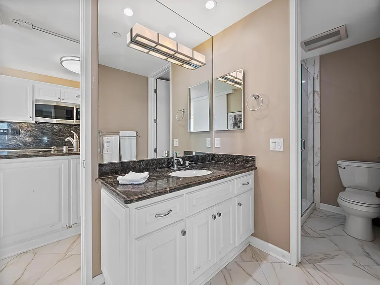 master bathroom with shower behind open door area