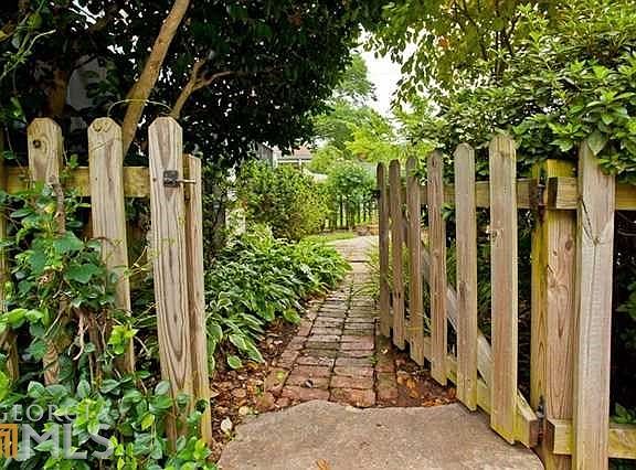 Private fenced front yard creates a cottage like atmosphere