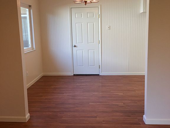View from kitchen to dining room and door to two car garage (kitchen is to the right of the dining area)