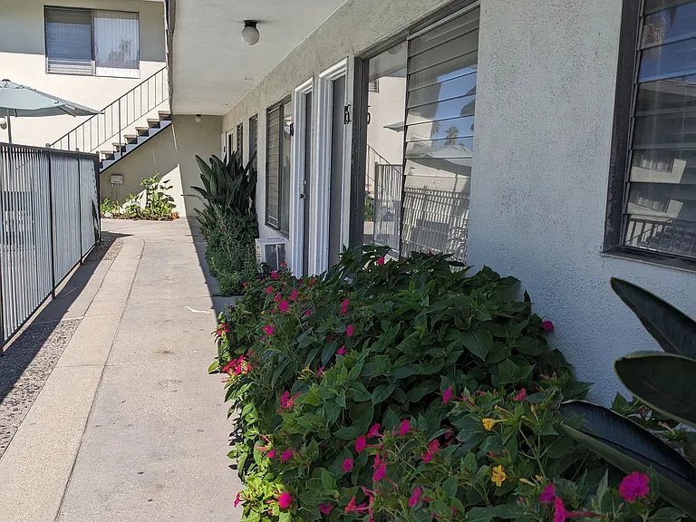 Flowering gardens along innear walkway to swimming pool and apartments at Los Robles in Pasadena, California.