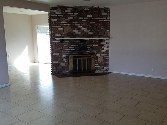 Spacious open living room with fireplace and dining room