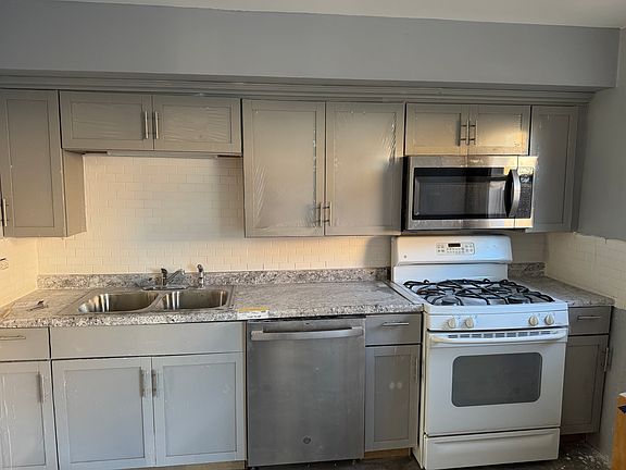 Newly remodeled kitchen with new cabinets, new dishwasher and new microwave.
