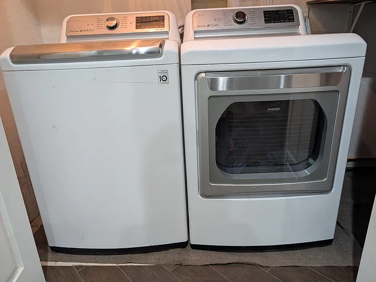 In-home laundry area with a full-size washer and matching front-load dryer for convenient, on-site laundry.