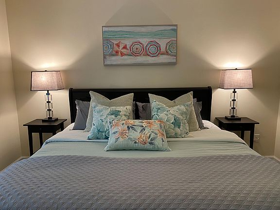 Well-appointed bedroom with a comfortable bed, matching nightstands, and bedside lighting for convenient reading.