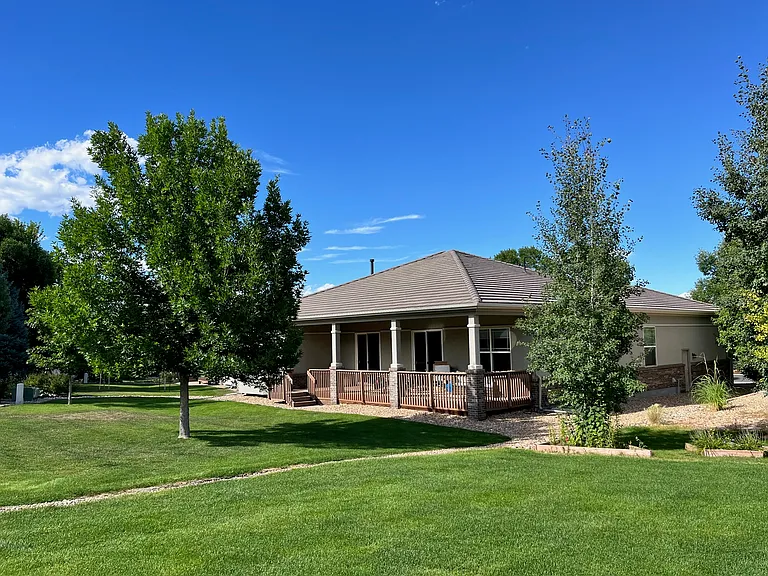 Rear view showing oversized yard and adjacent open space