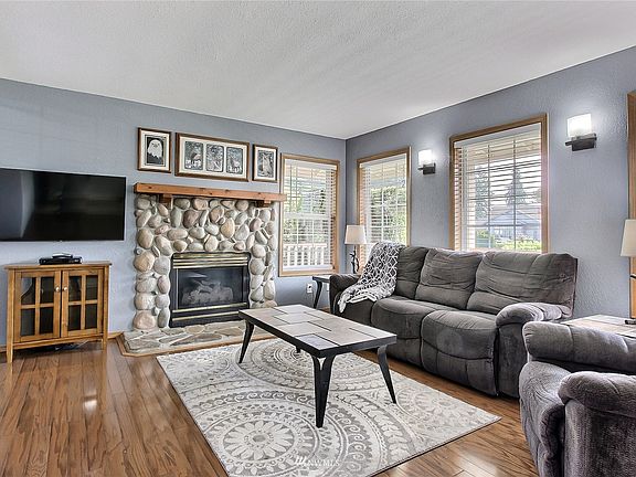 Shot of the family room from entry, newer sconces and dining room it to your left. Look at that fireplace! 