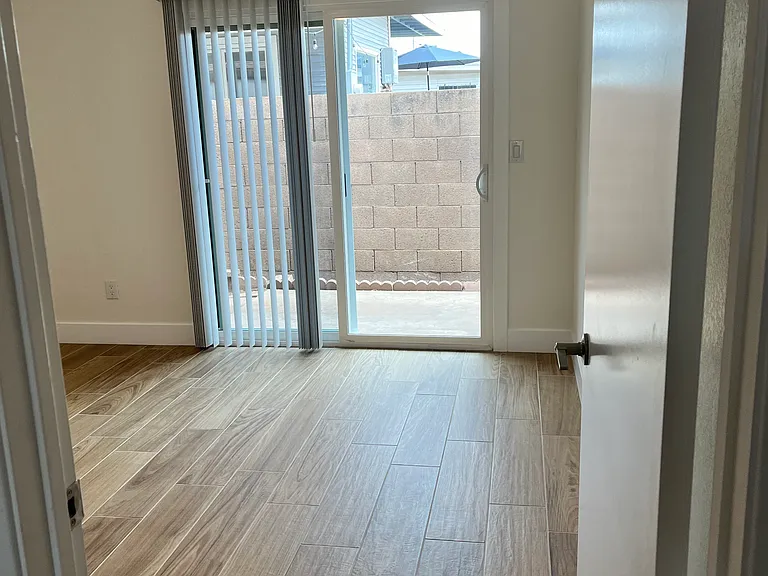 Bedroom 1 with sliding glass door to patio