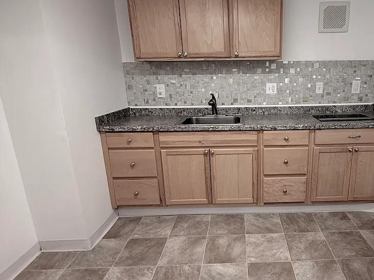 New kitchen, 6 drawers in cabinets, built-in cooktop, exhaust fan, recessed lighting fixture.