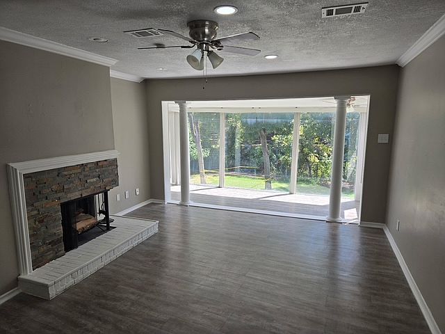 Large living area with fireplace that extends into sunroom.