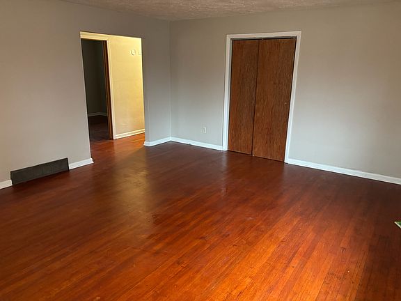 Coat closet and doorway leading to hallway with bedrooms