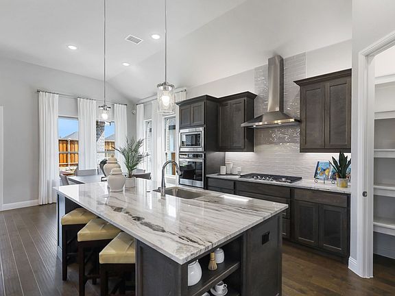 Kitchen in the Allure home plan by Trophy Signature Homes - REPRESENTATIVE PHOTO