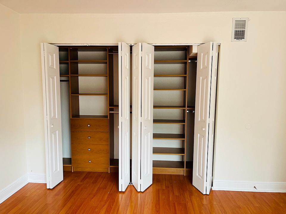 California closet in back bedroom. New closet tracks and new vertical blinds.