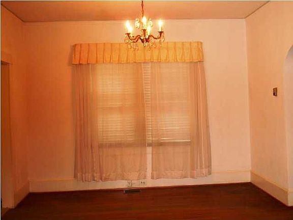 Spacious dining room showing off the hardwood floors.