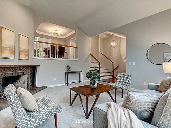 View from the formal living room up to the dining room with custom white-oak stair case and architectural handrailing.