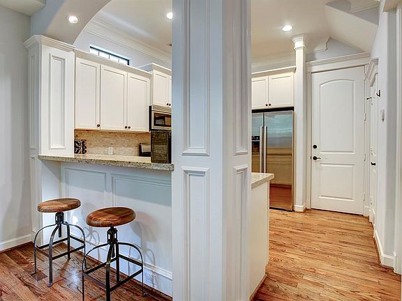 Entrance into the kitchen, garage and half bath. Lots of decorative moulding adds to the upscale elegant look in this home .