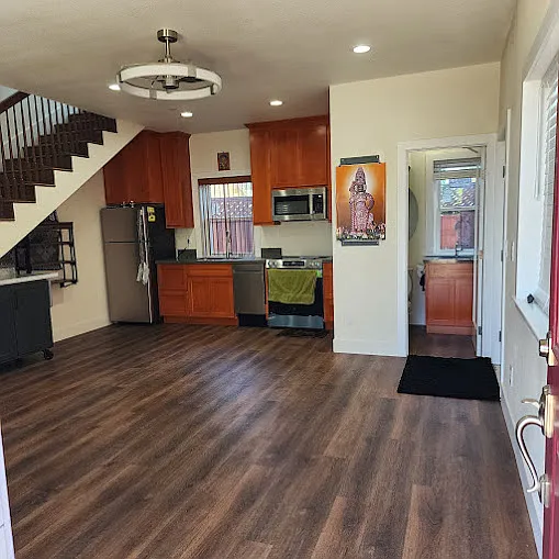 Main door opens into the Living / Dining hall with open kitchen at far left corner and 1/2 bath in the right corner.
